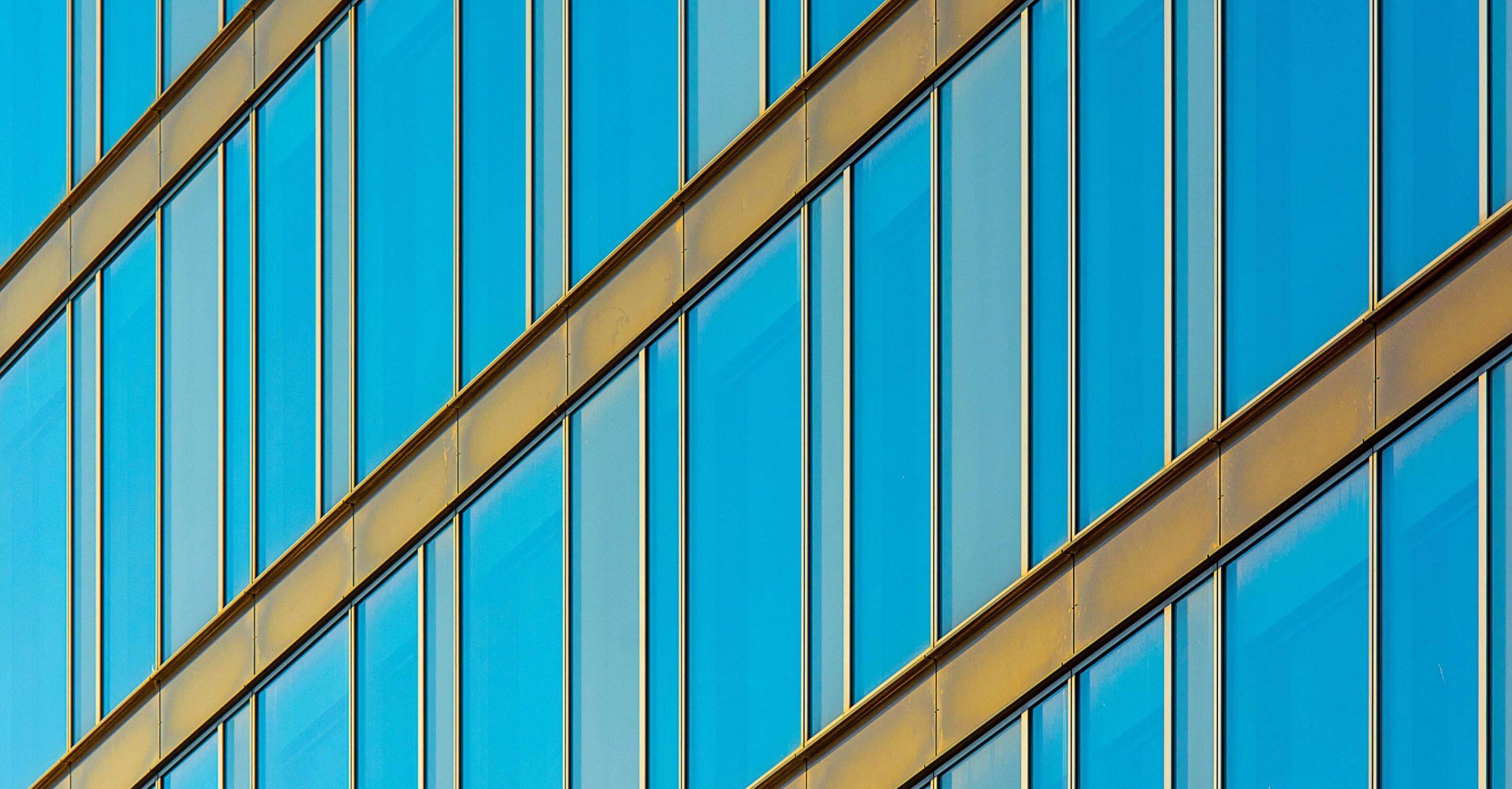 Large areas of glass facade can contribute to building overheating without effective external solar shading.